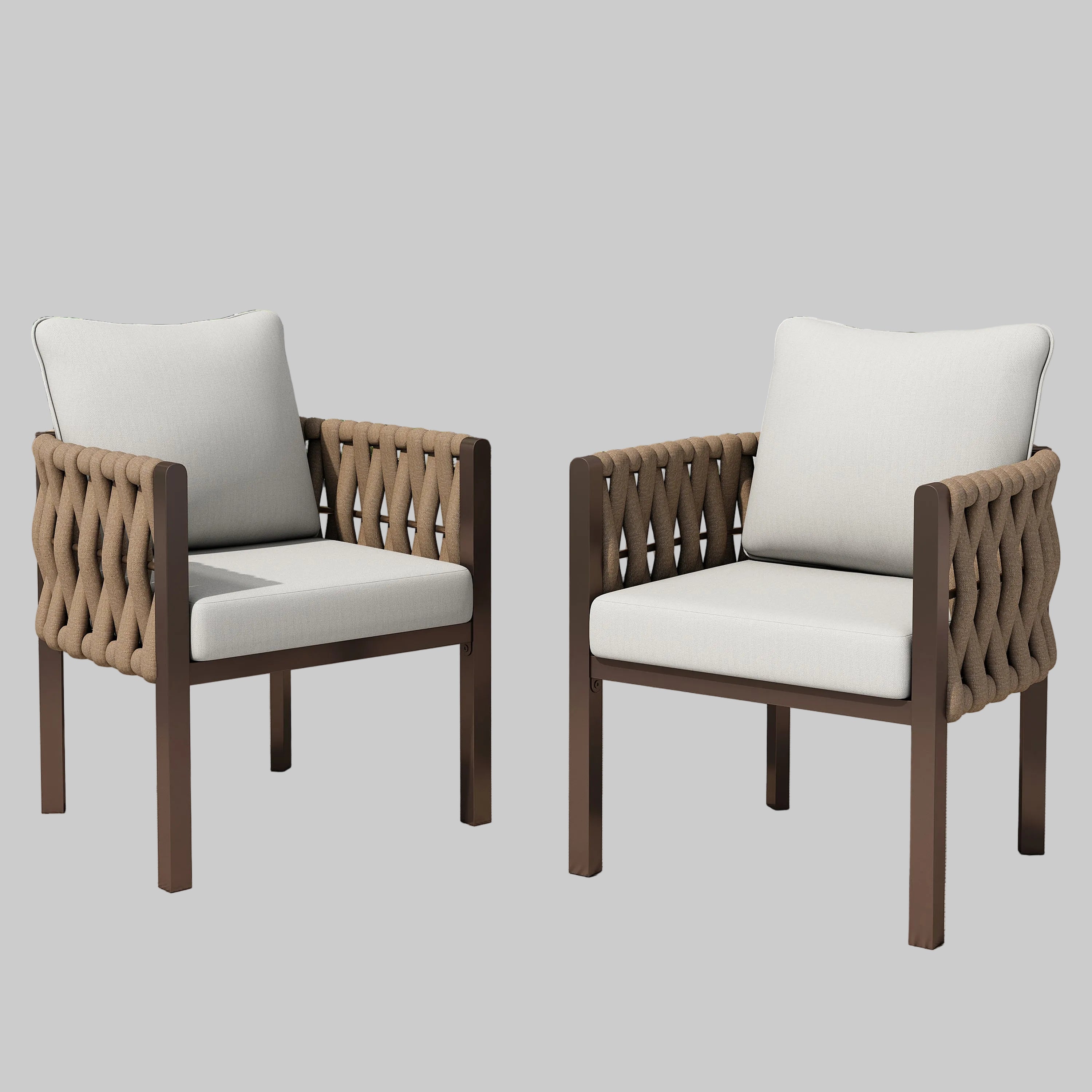 A pair of modern brown metal patio club chairs with light grey cushions and woven rope design on a backyard patio.