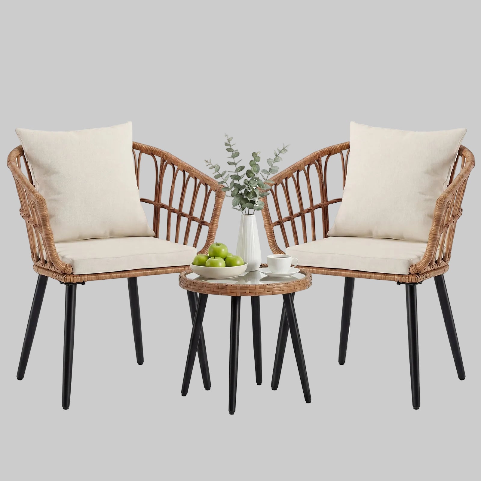 A brown 3-piece PE rattan outdoor bistro set with two padded chairs and a tempered glass-top table on a cozy apartment balcony.