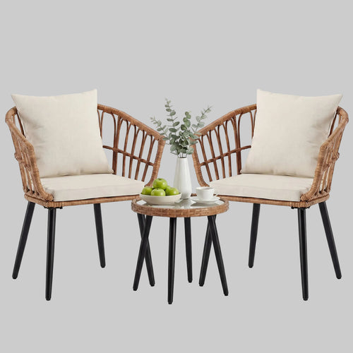A brown 3-piece PE rattan outdoor bistro set with two padded chairs and a tempered glass-top table on a cozy apartment balcony.