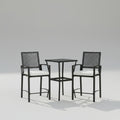 A 3-piece outdoor rattan wicker bar set featuring a high-top table and two cushioned tall armchairs arranged by a poolside deck.