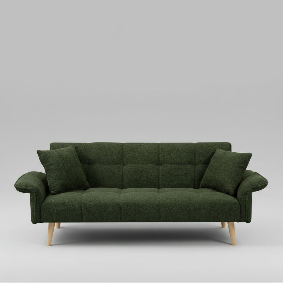 Green sofa in a living room with decorative elements and a lamp.