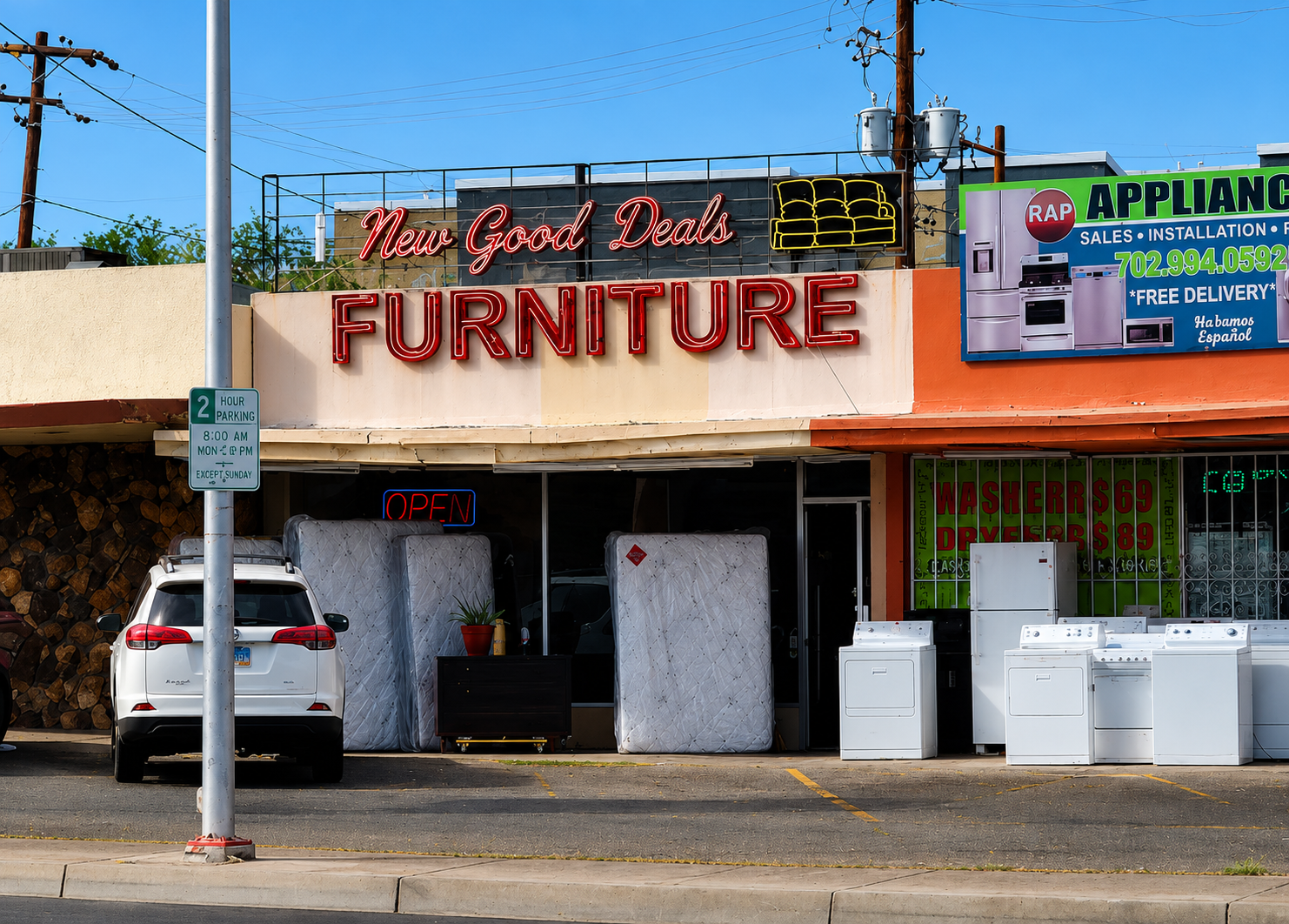 Furniture store with 'New Good Deals Furniture' sign and appliances outside.