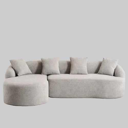 Light Grey compression sectional sofa with chaise lounge upholstered in chenille fabric featuring full sponge cushions and four matching pillows.