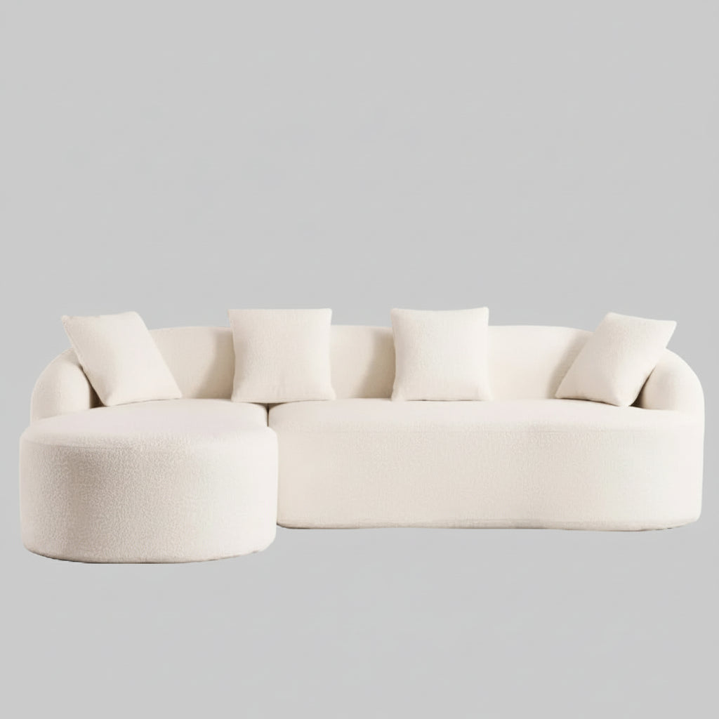 white compression sectional sofa with chaise lounge upholstered in chenille fabric featuring full sponge cushions and four matching pillows.
